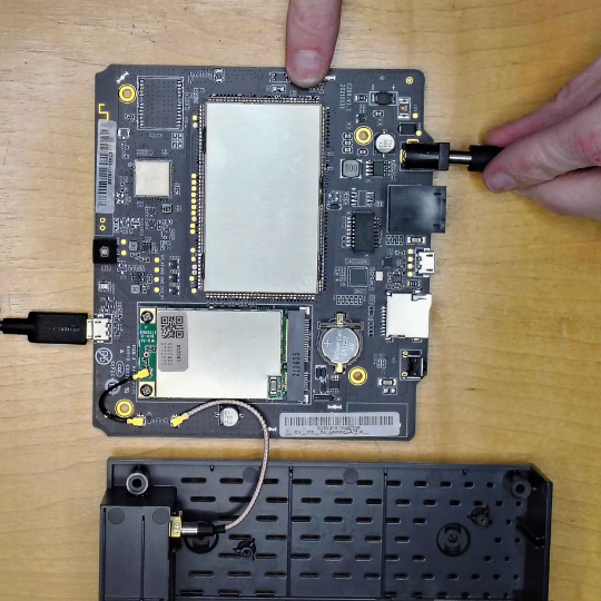 Holding the Recovery button while plugging in the power cable — the USB cable is already connected