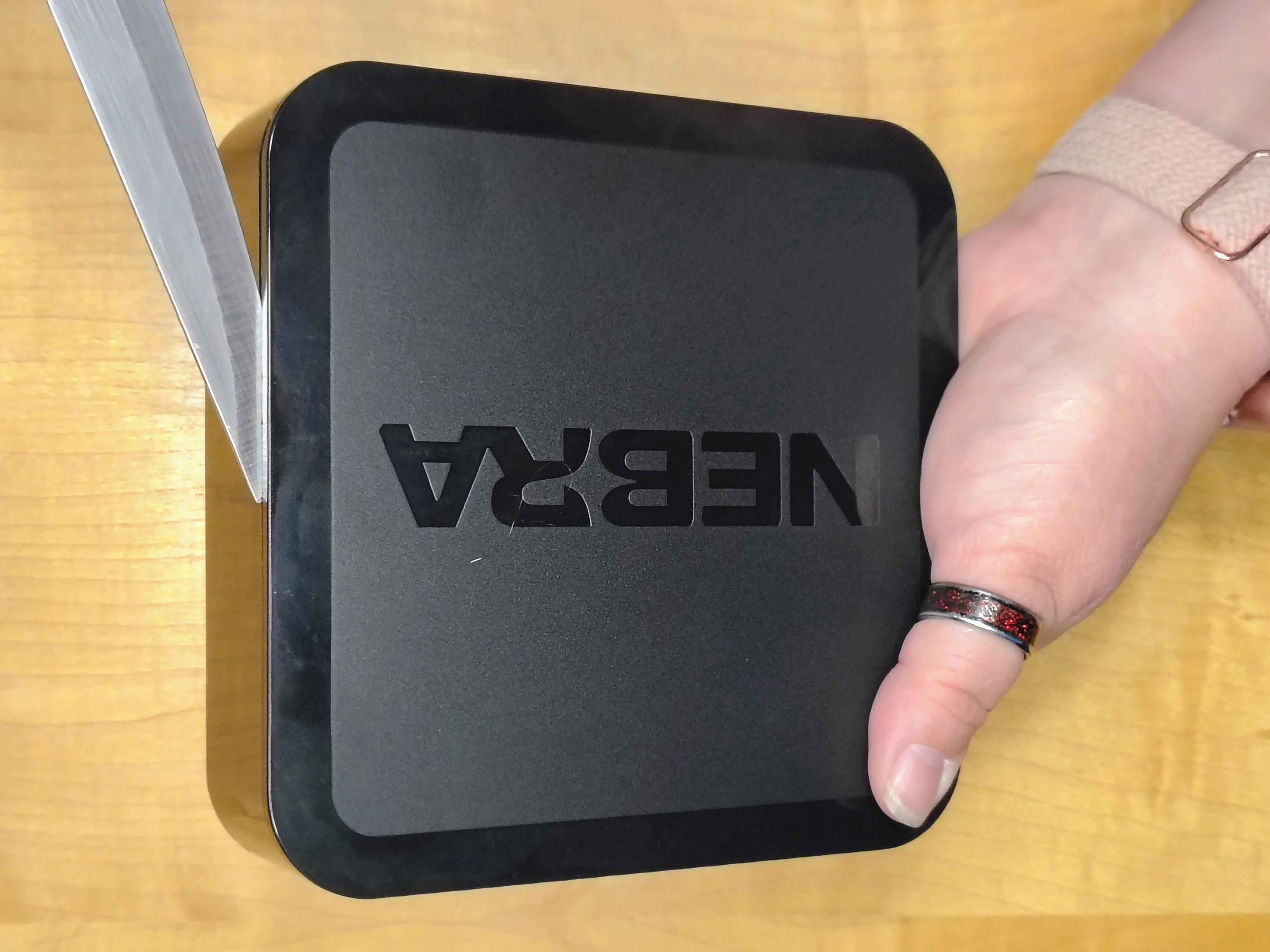 Prying the top cover off the Nebra with a thin tool