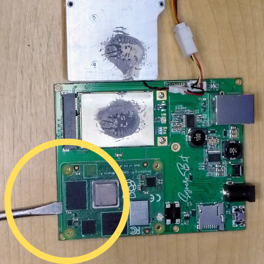 Gently pry the Compute Module 4 off the carrier board with a flathead screwdriver